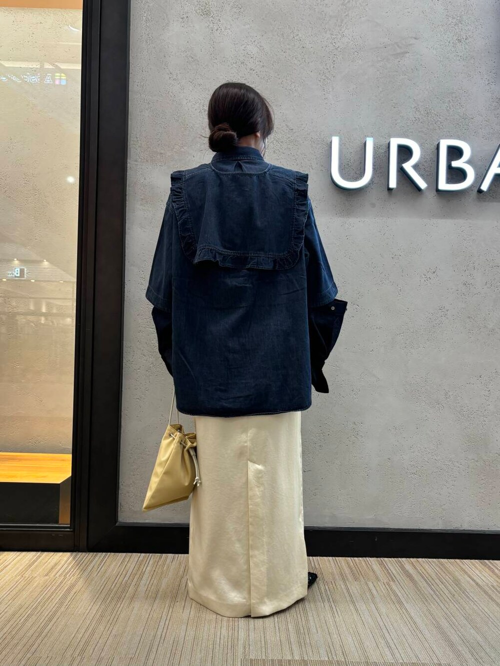 ホワイト系のスカート、ブラック系のシャツ/ブラウス、イエロー系のショルダーバッグを着用したレディースの夏コーディネートの3枚目の写真