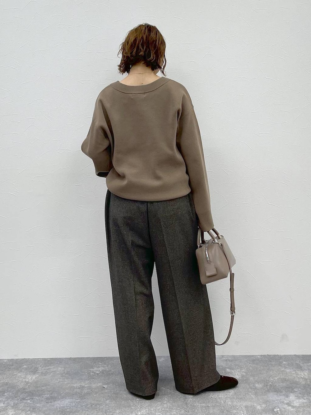 ベージュ系のニット/セーター、ブラウン系のその他パンツ、ブラウン系のパンプスを着用したレディースの秋コーディネートの3枚目の写真