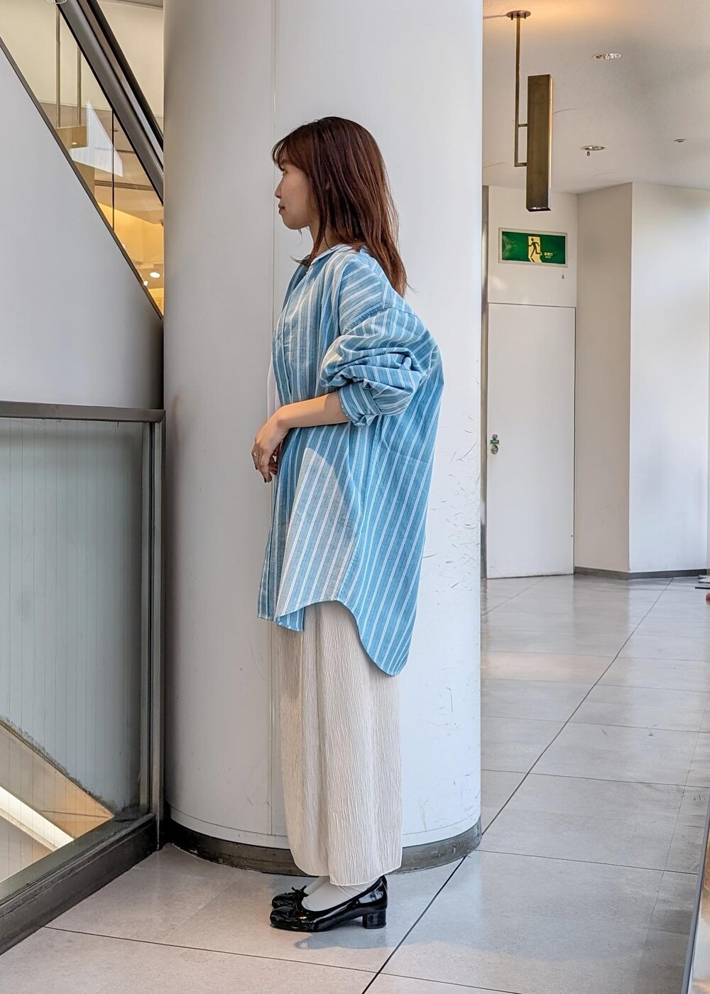 ホワイト系のTシャツ/カットソー、ベージュ系のスカート、グリーン系のシャツ/ブラウスを着用したレディースの春コーディネートの4枚目の写真