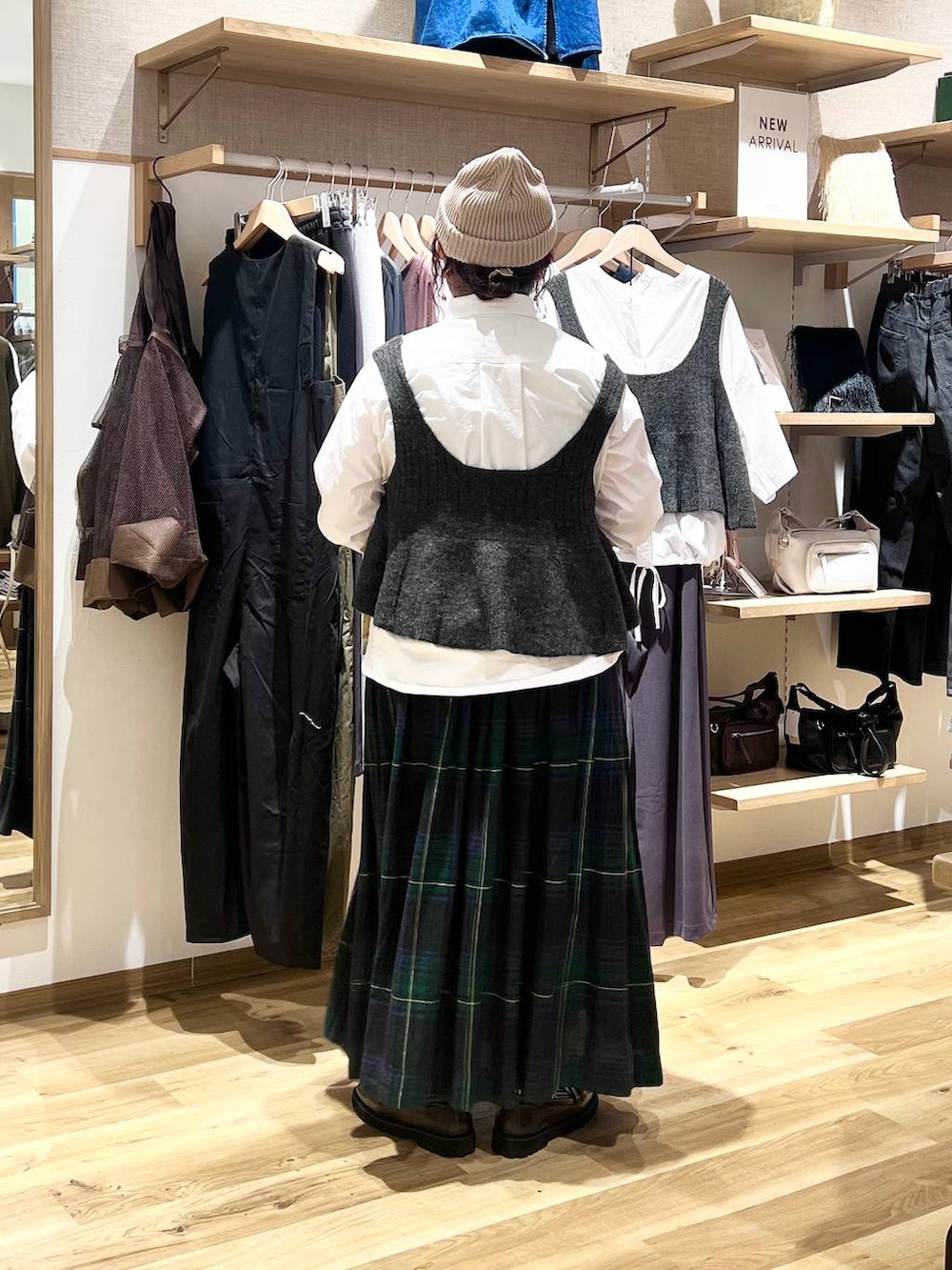 ブラウン系のローファー、ベージュ系のショルダーバッグ、グリーン系のスカートを着用したレディースの秋コーディネートの4枚目の写真