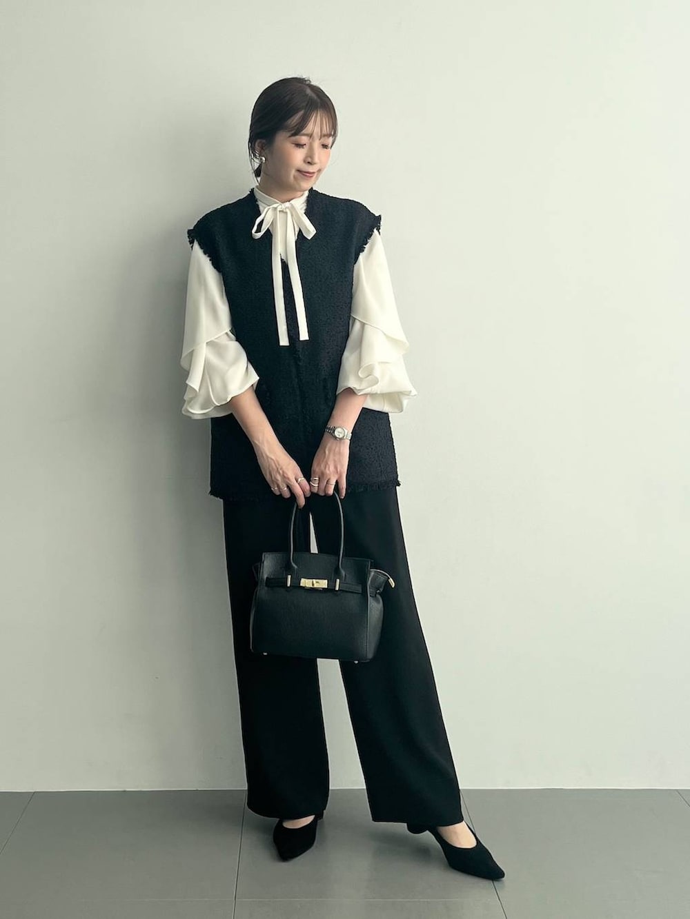 ブラック系のショルダーバッグ、ブラック系のその他パンツ、ホワイト系のシャツ/ブラウスを着用したレディースの冬コーディネートの7枚目の写真