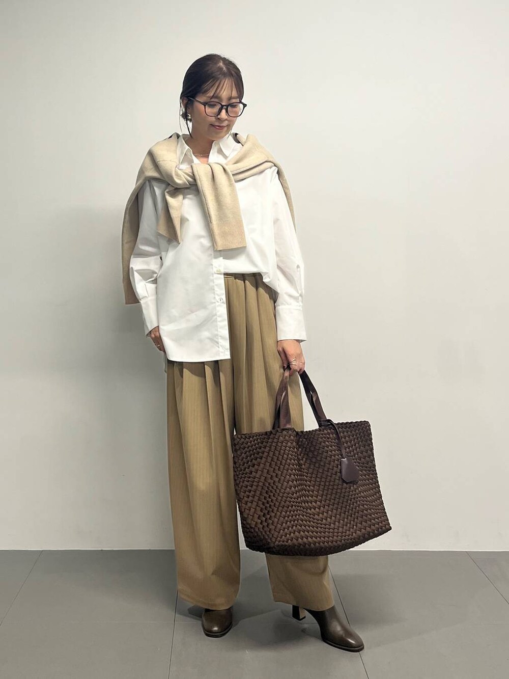 ブラウン系のブーツ、イエロー系のその他パンツ、ベージュ系のカーディガン/ボレロを着用したレディースの冬コーディネートの7枚目の写真