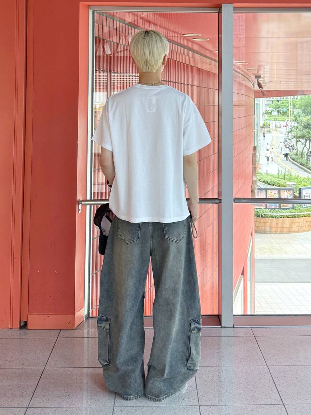 ホワイト系のTシャツ/カットソー、ブルー系のカーゴパンツ、ブラック系のキャップを着用したメンズの夏コーディネートの3枚目の写真
