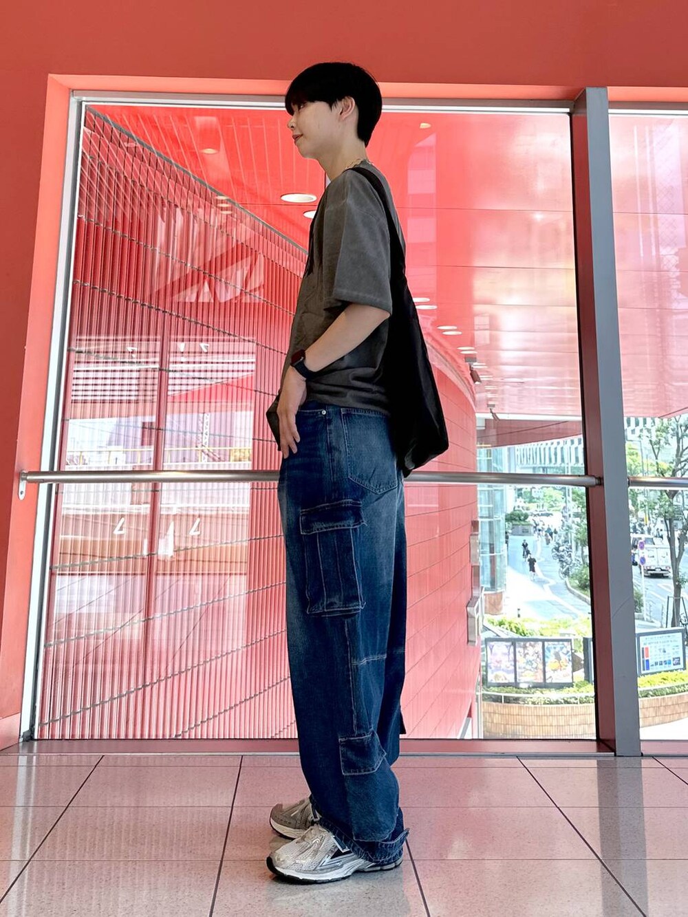 ブルー系のデニムパンツ、ブラック系のショルダーバッグ、グレー系のTシャツ/カットソーを着用したメンズの夏コーディネートの2枚目の写真
