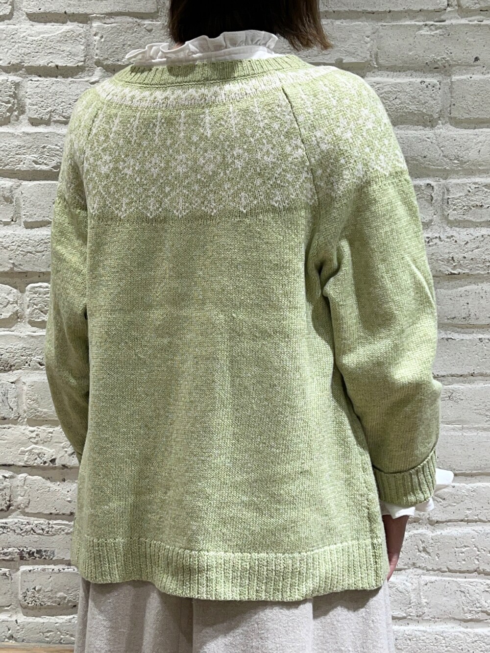 ホワイト系のシャツ/ブラウス、グリーン系のカーディガン/ボレロ、ホワイト系のトートバッグを着用したレディースの冬コーディネートの5枚目の写真