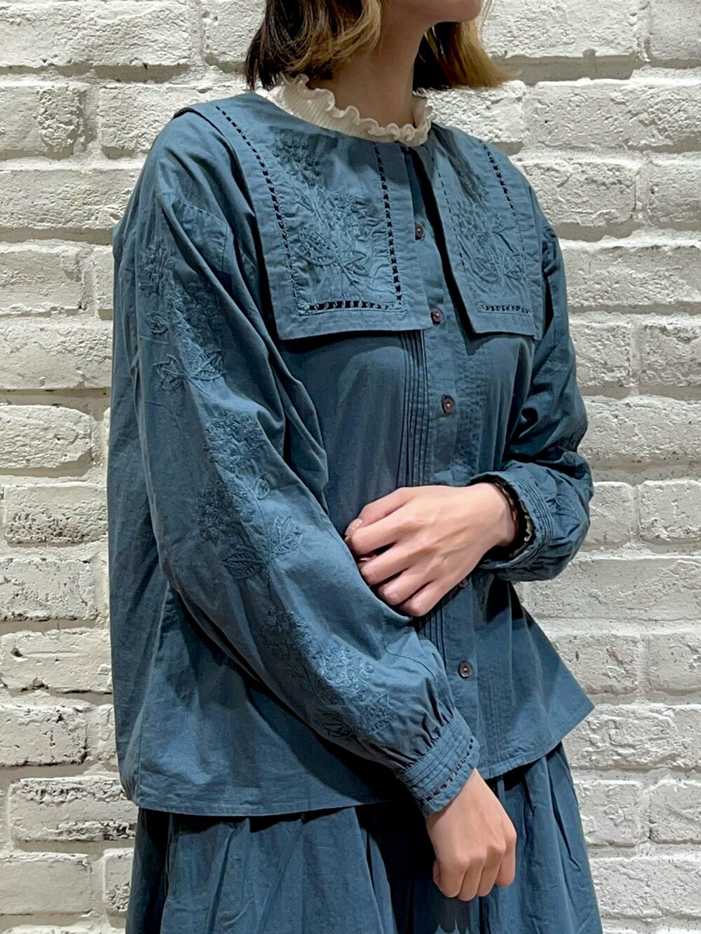 ホワイト系のTシャツ/カットソー、グリーン系のシャツ/ブラウス、グリーン系のスカートを着用したレディースの秋コーディネートの2枚目の写真
