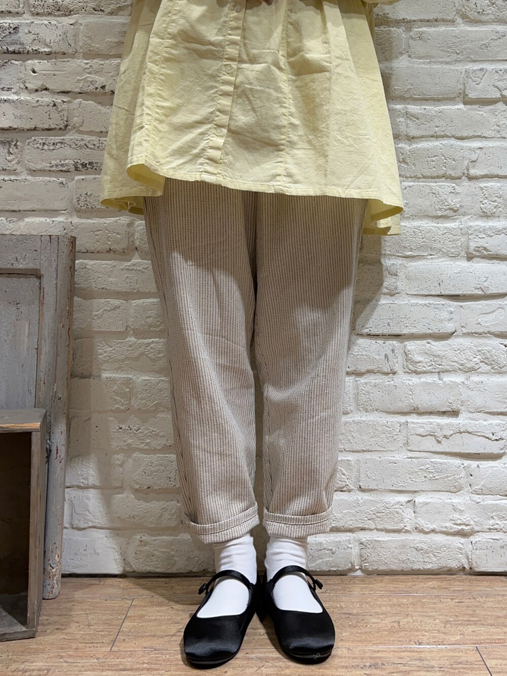 ホワイト系のカーディガン/ボレロ、イエロー系のシャツ/ブラウス、ホワイト系のTシャツ/カットソーを着用したレディースの春コーディネートの3枚目の写真