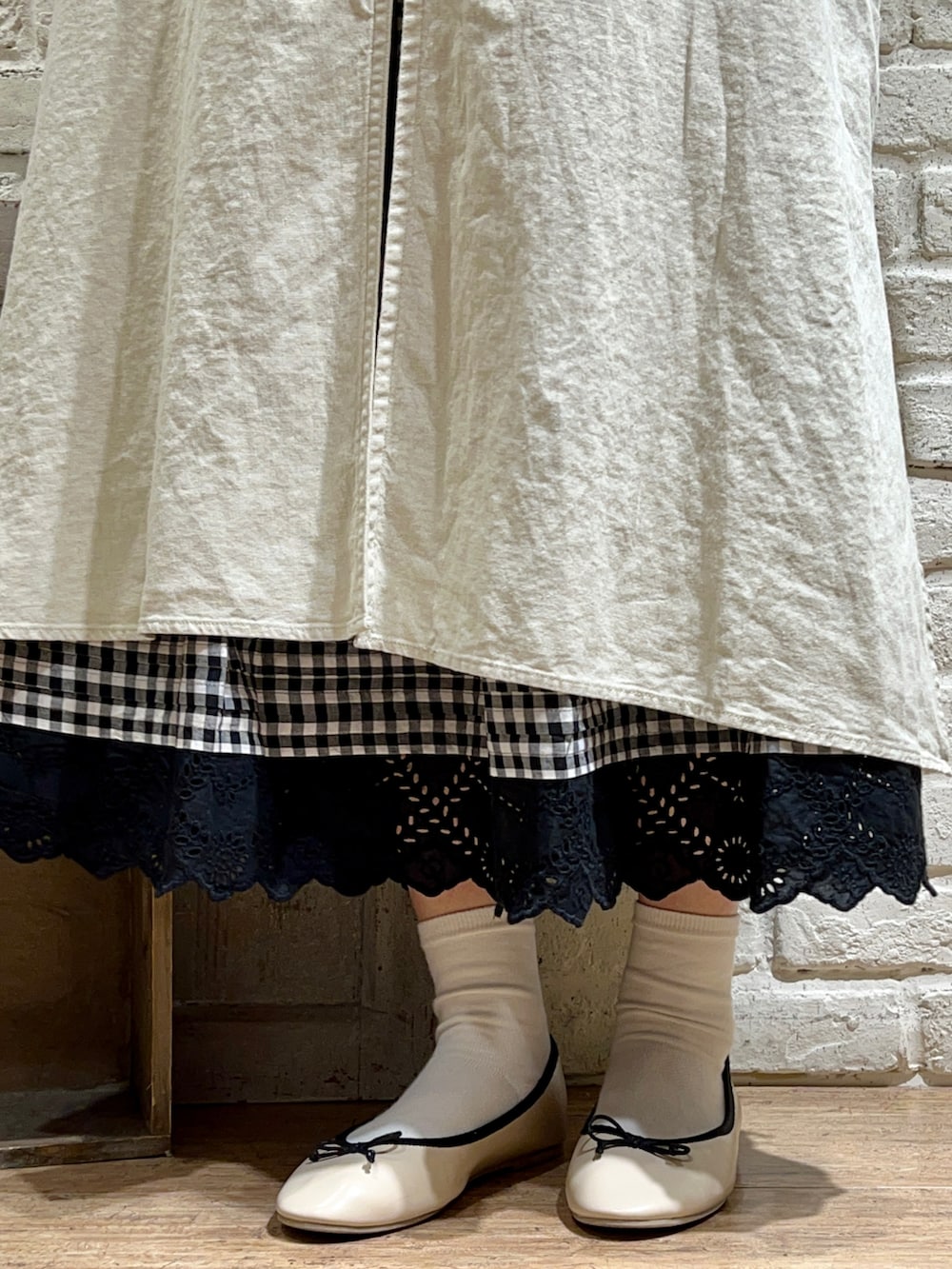 ブラック系のシャツ/ブラウス、ホワイト系のカーディガン/ボレロ、ホワイト系のワンピースを着用したレディースの春コーディネートの5枚目の写真