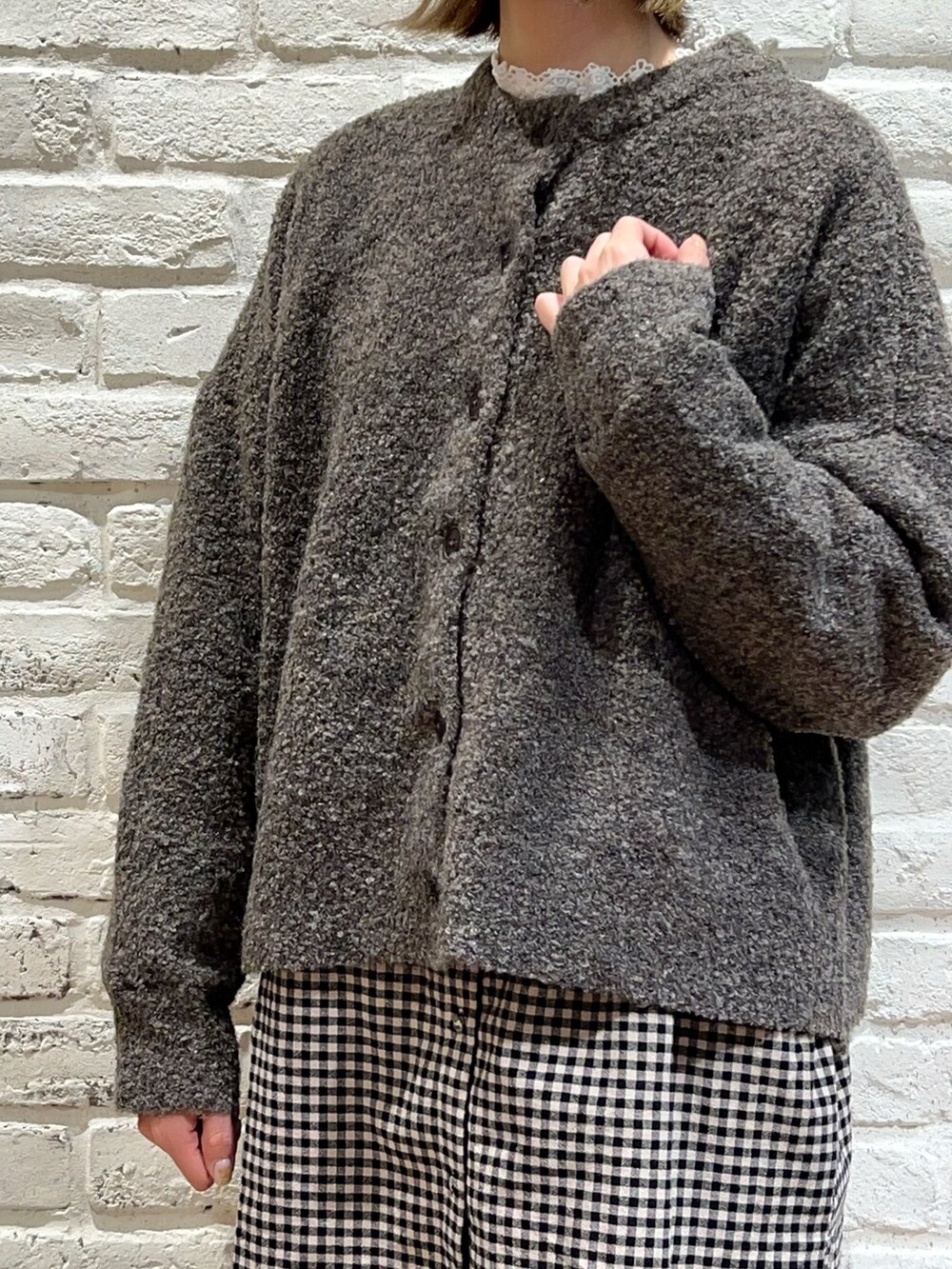 ホワイト系のTシャツ/カットソー、ブラウン系のカーディガン/ボレロ、ブラック系のチュニックを着用したレディースの秋コーディネートの2枚目の写真