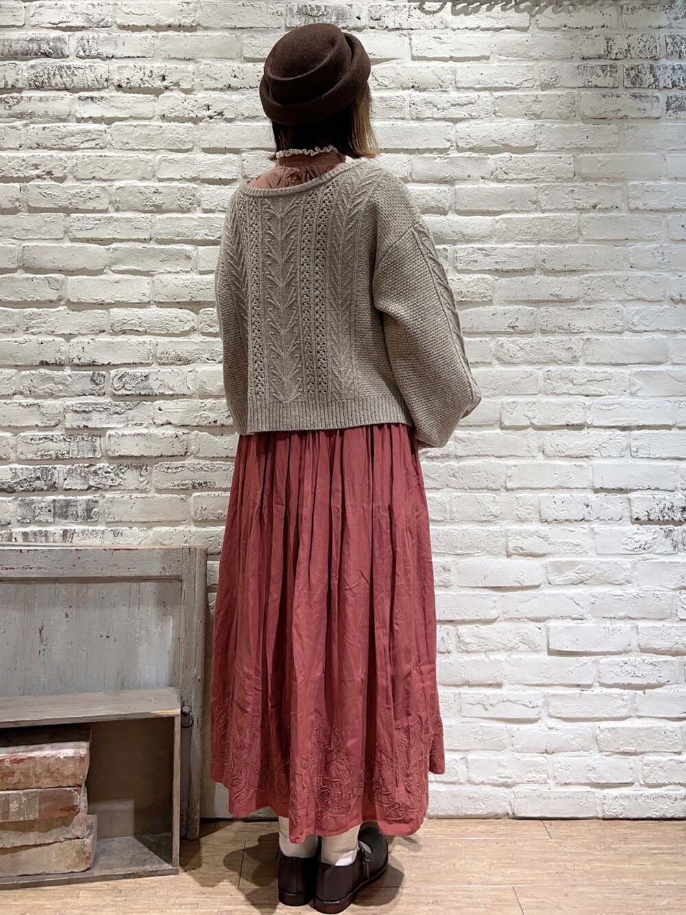 ホワイト系のニット/セーター、ベージュ系のカーディガン/ボレロ、ベージュ系のスカートを着用したレディースの秋コーディネートの5枚目の写真