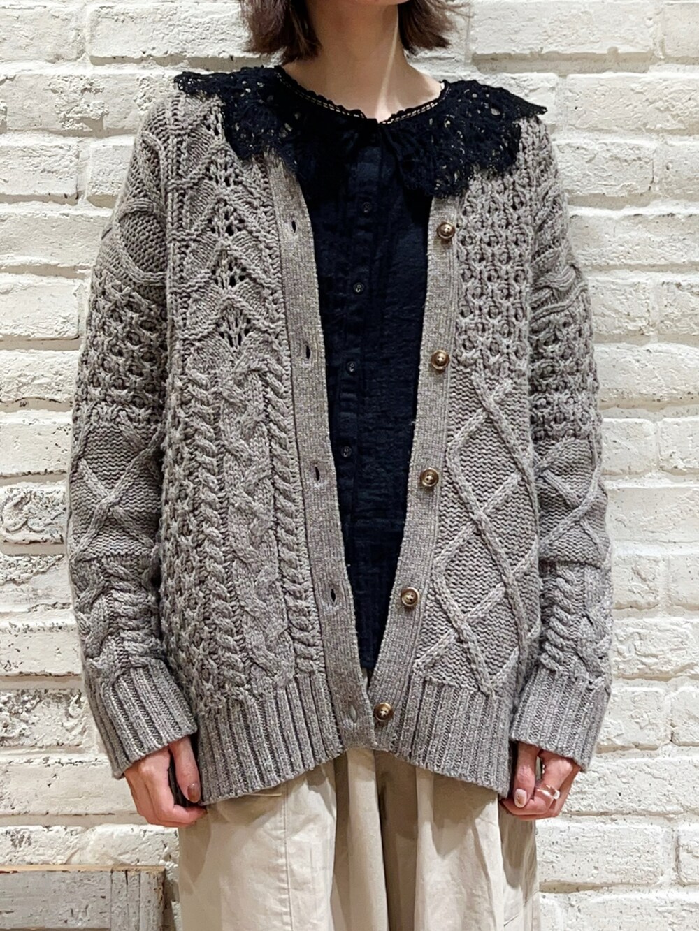 ブラック系のシャツ/ブラウス、ブラウン系のカーディガン/ボレロ、ベージュ系のカーゴパンツを着用したレディースの冬コーディネートの2枚目の写真