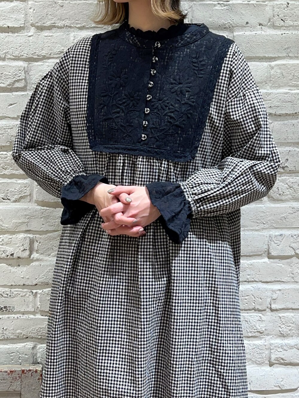 ブラック系のシャツ/ブラウス、ホワイト系のカーディガン/ボレロ、ブラック系のドレスシューズを着用したレディースの冬コーディネートの2枚目の写真