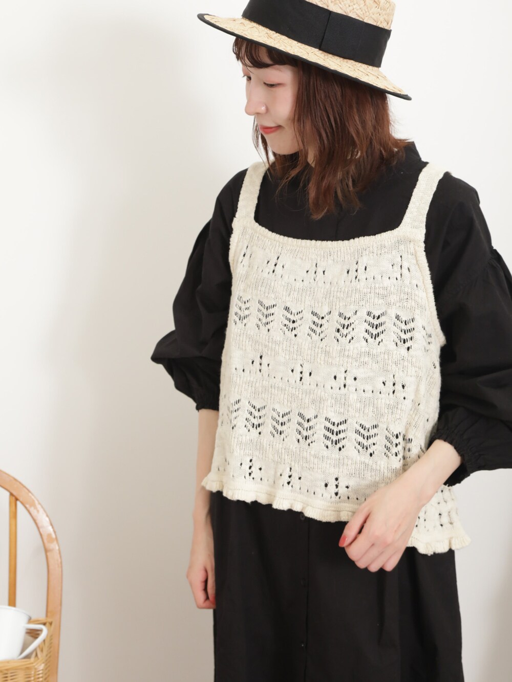 ホワイト系のベスト、ブラック系のワンピース、ブルー系のその他パンツを着用したレディースの春コーディネートの3枚目の写真