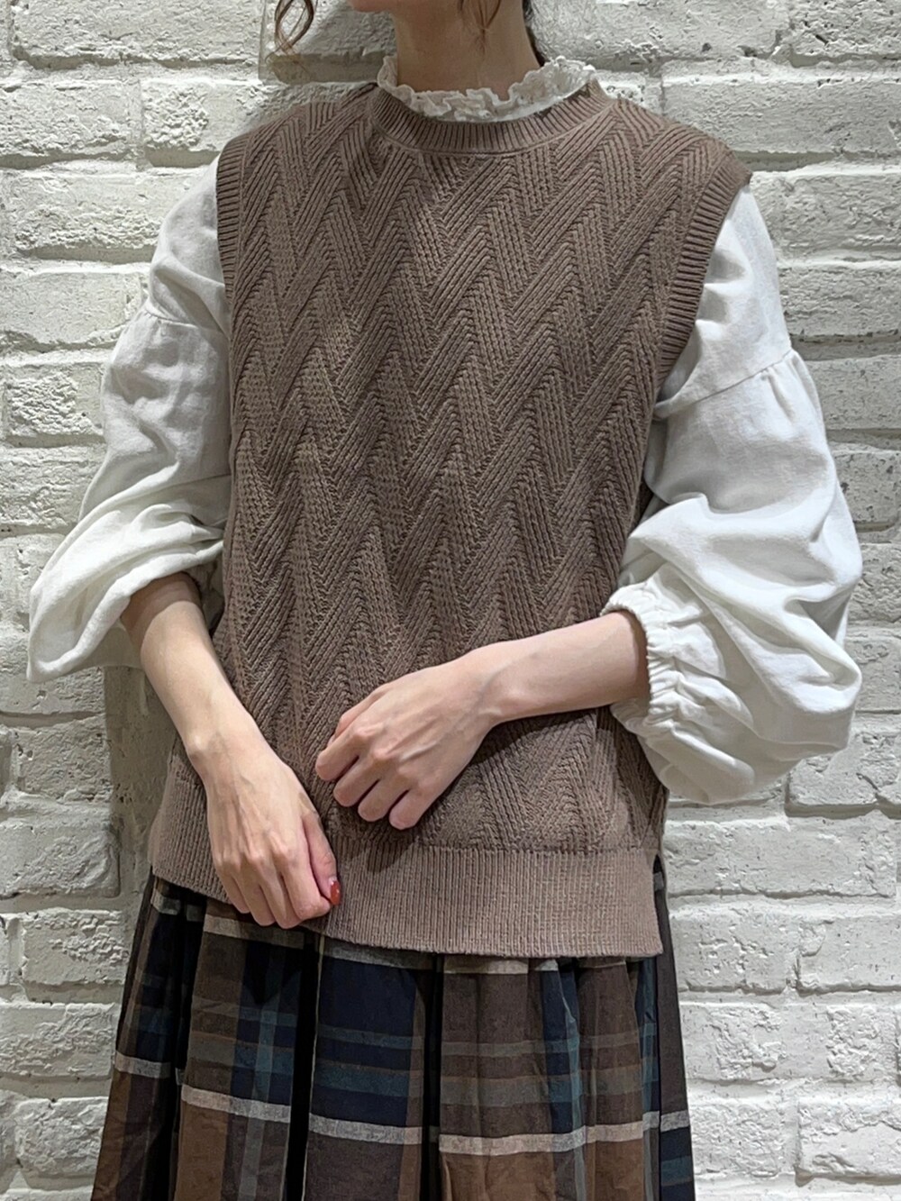 ホワイト系のシャツ/ブラウス、ベージュ系のブルゾン、ブラウン系のベストを着用したレディースの秋コーディネートの3枚目の写真