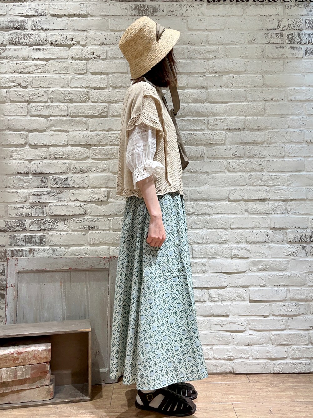 ホワイト系のシャツ/ブラウス、ホワイト系のベスト、グリーン系のスカートを着用したレディースの春コーディネートの3枚目の写真