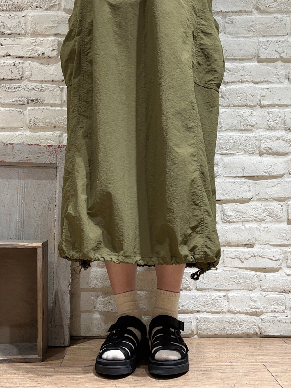 ホワイト系のTシャツ/カットソー、グリーン系のワンピース、ホワイト系のハンドバッグを着用したレディースの夏コーディネートの5枚目の写真