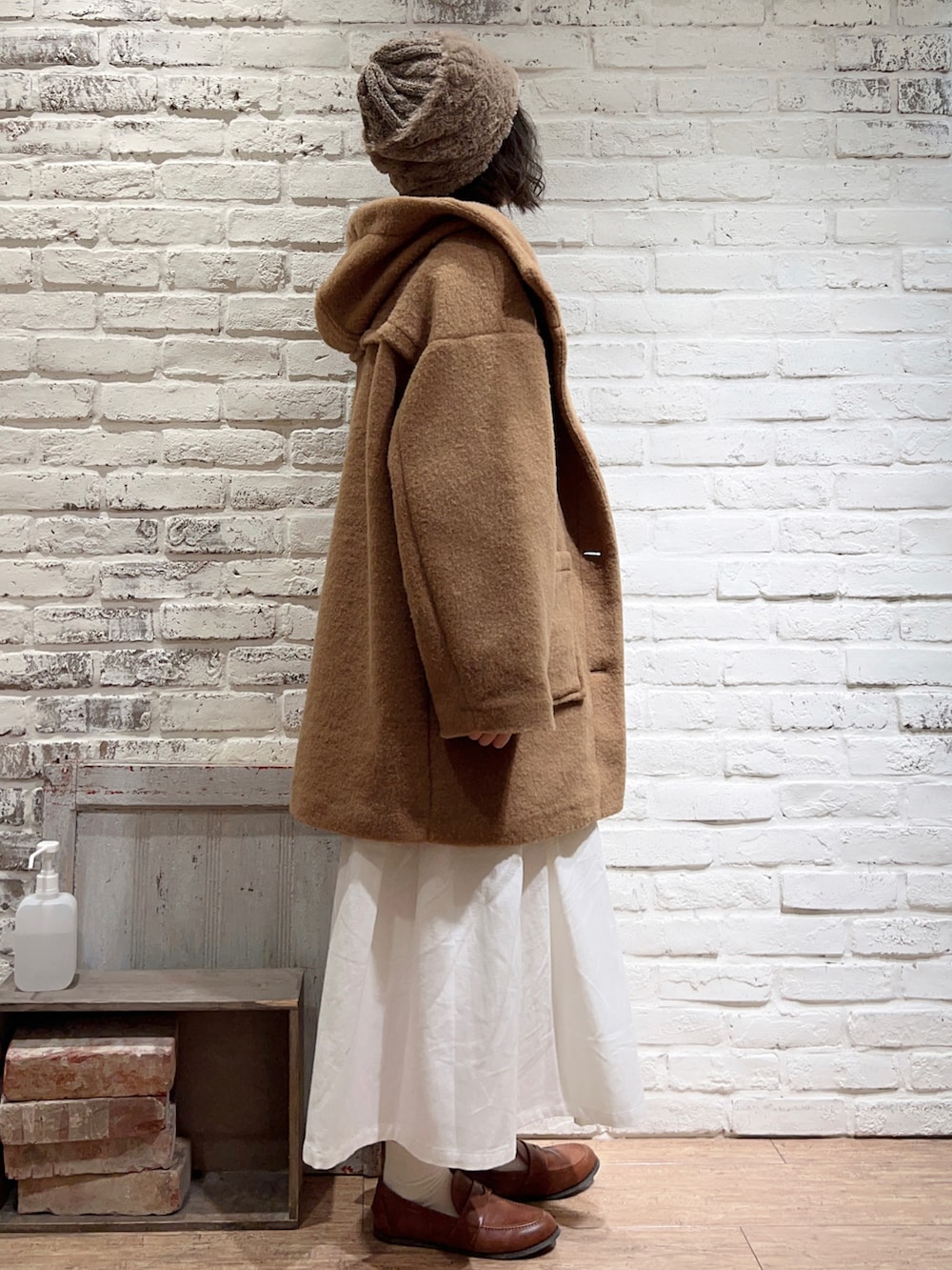 ホワイト系のニット/セーター、イエロー系のその他アウター、グレー系のシャツ/ブラウスを着用したレディースの冬コーディネートの3枚目の写真