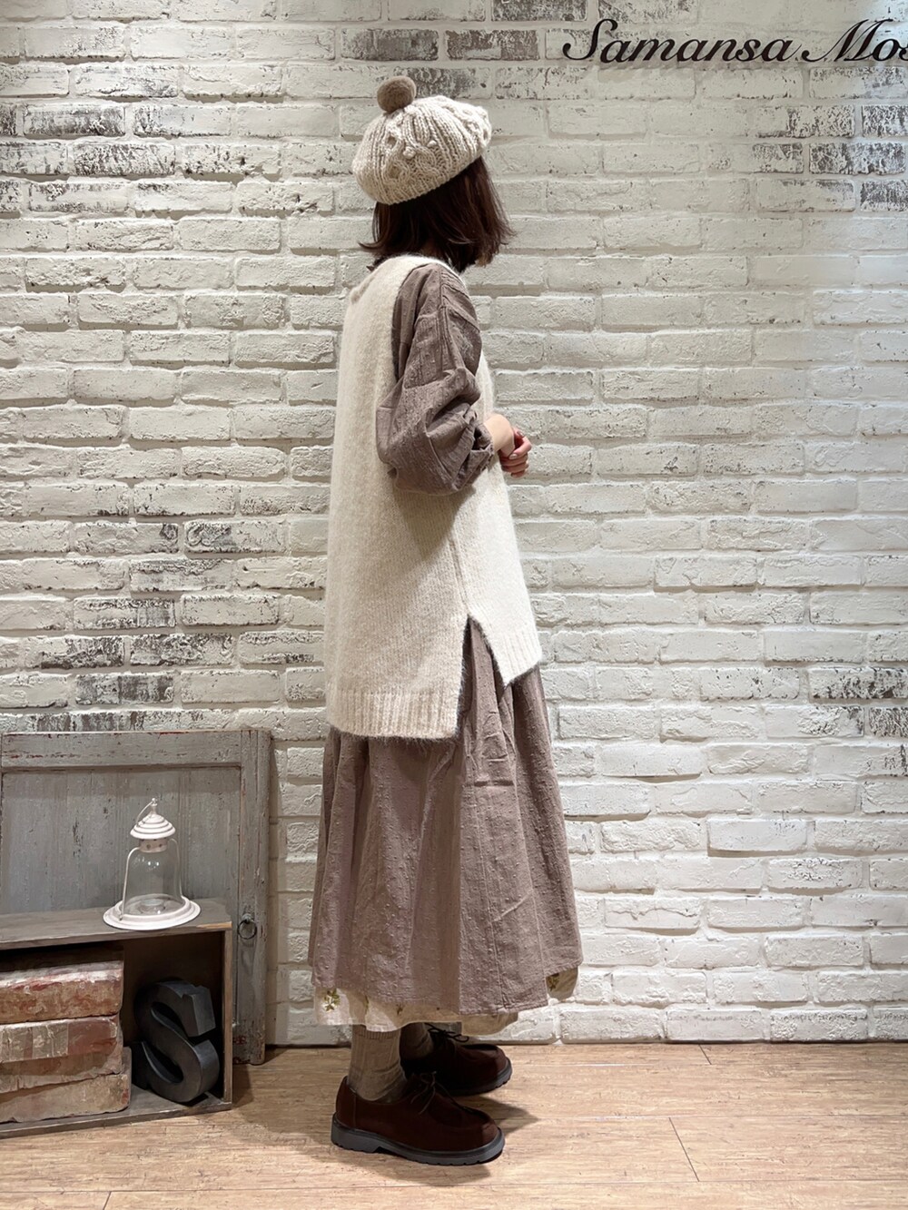 ホワイト系のTシャツ/カットソー、ホワイト系のベスト、ブラウン系のワンピースを着用したレディースの冬コーディネートの4枚目の写真