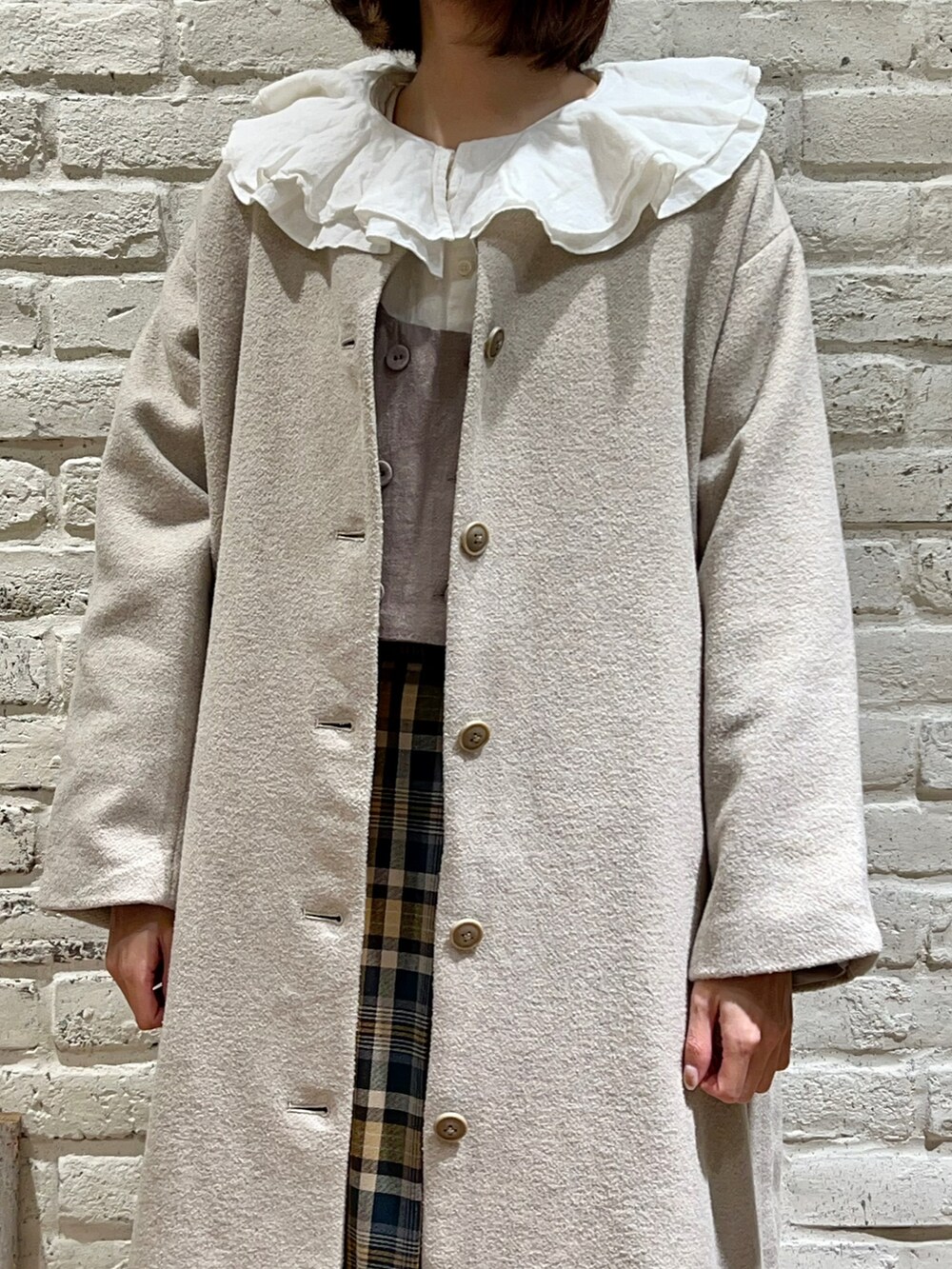 ホワイト系のシャツ/ブラウス、ブラウン系のベスト、ベージュ系のその他アウターを着用したレディースの冬コーディネートの2枚目の写真