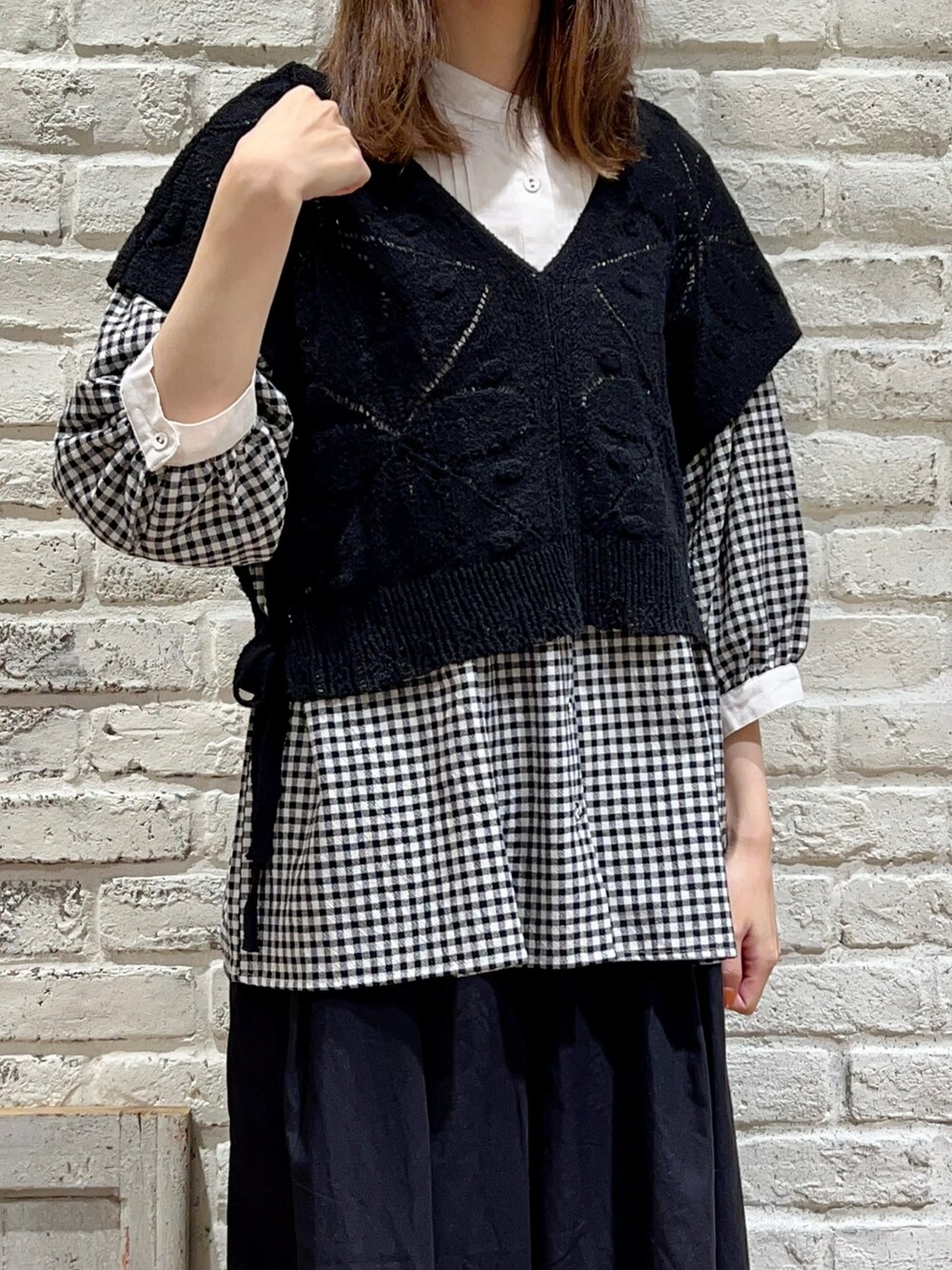 ブラック系のベスト、ブラック系のシャツ/ブラウス、ブラック系のハンドバッグを着用したレディースの秋コーディネートの2枚目の写真