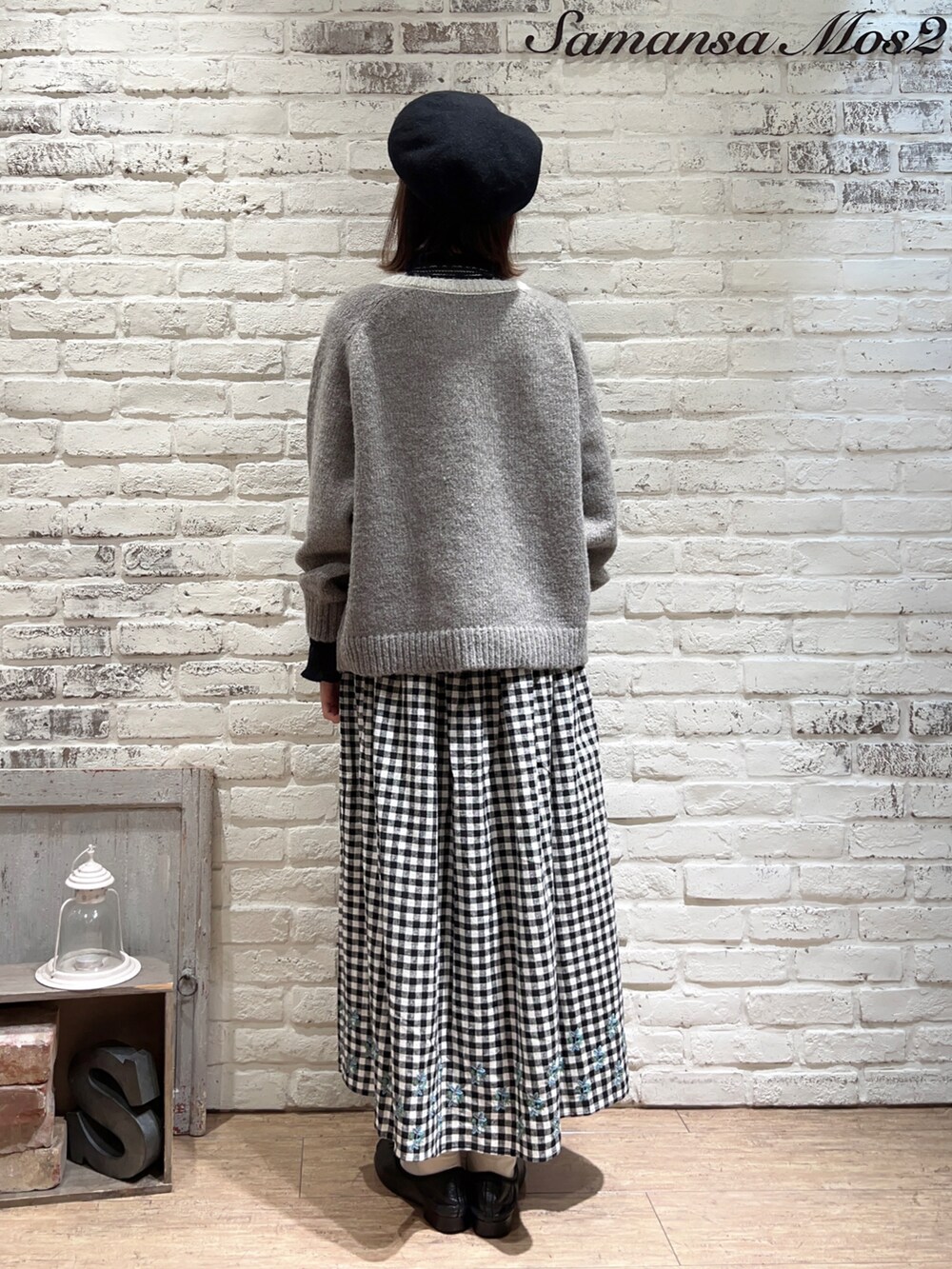 ブラック系のニット/セーター、ベージュ系のカーディガン/ボレロ、ベージュ系のスカートを着用したレディースの冬コーディネートの4枚目の写真