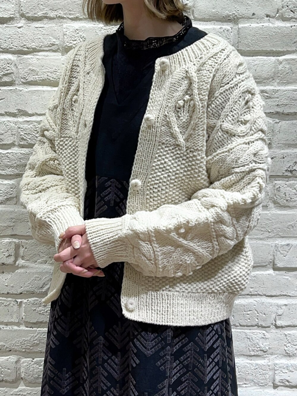 ブラック系のシャツ/ブラウス、ホワイト系のカーディガン/ボレロ、ブラック系のワンピースを着用したレディースの秋コーディネートの2枚目の写真