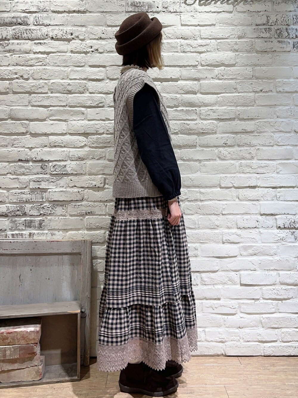 ホワイト系のニット/セーター、ベージュ系のベスト、ブラック系のシャツ/ブラウスを着用したレディースの秋コーディネートの3枚目の写真