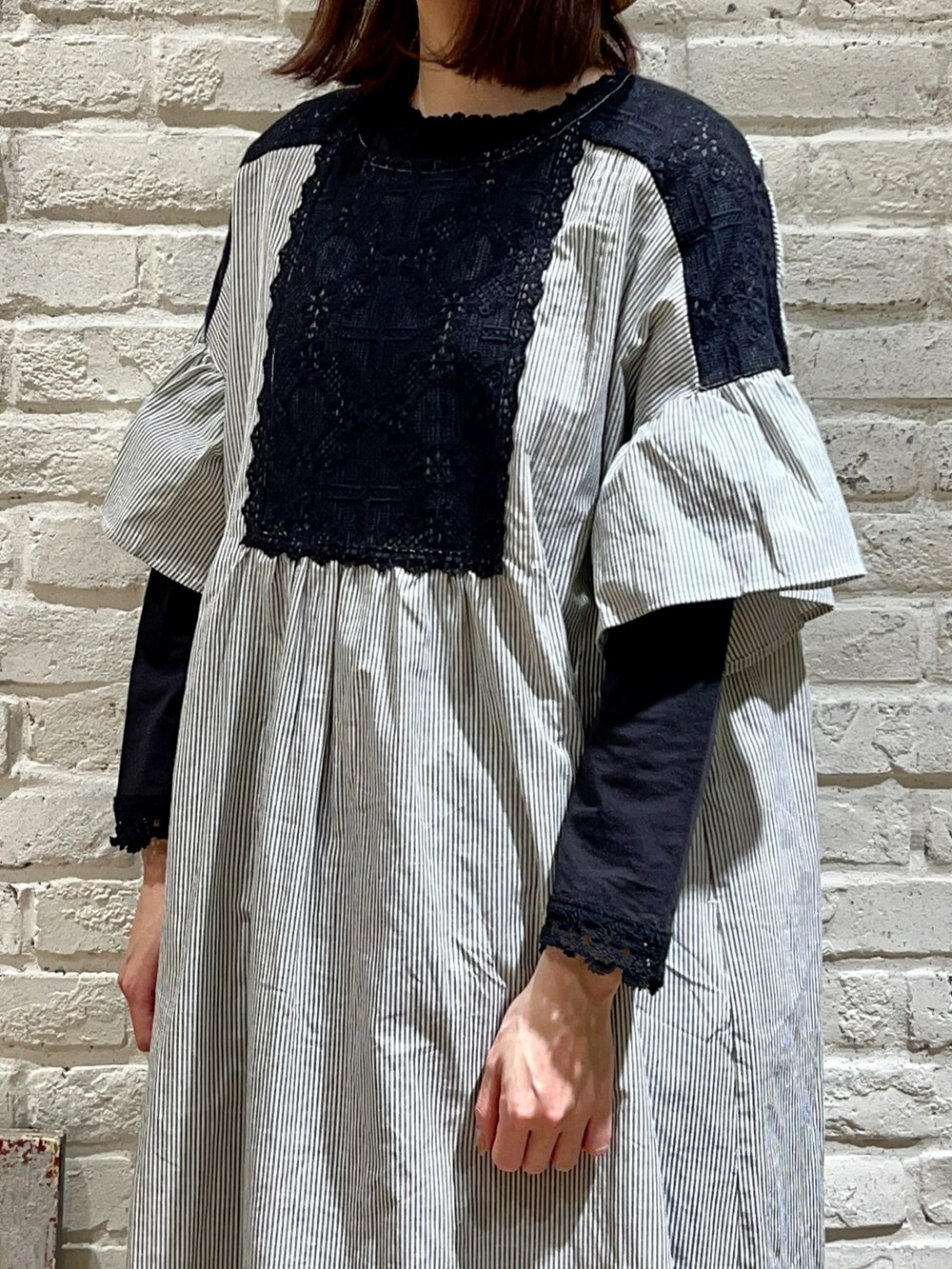 ブラック系のTシャツ/カットソー、ブラック系のハンドバッグ、ブラック系のワンピースを着用したレディースの春コーディネートの2枚目の写真