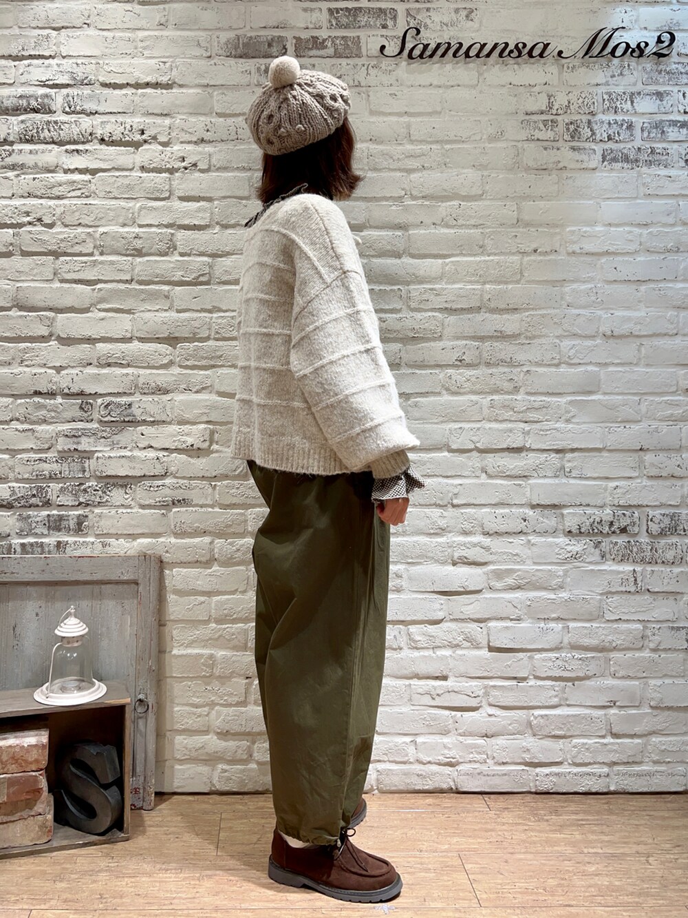 ブラウン系のシャツ/ブラウス、ホワイト系のカーディガン/ボレロ、グリーン系のサロペット/オーバーオールを着用したレディースの冬コーディネートの4枚目の写真