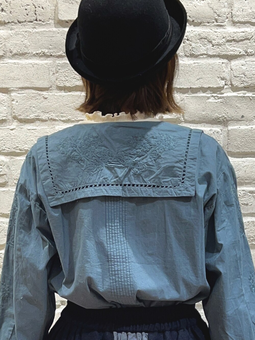 ホワイト系のTシャツ/カットソー、グリーン系のシャツ/ブラウス、ベージュ系のノーカラーコートを着用したレディースの秋コーディネートの5枚目の写真