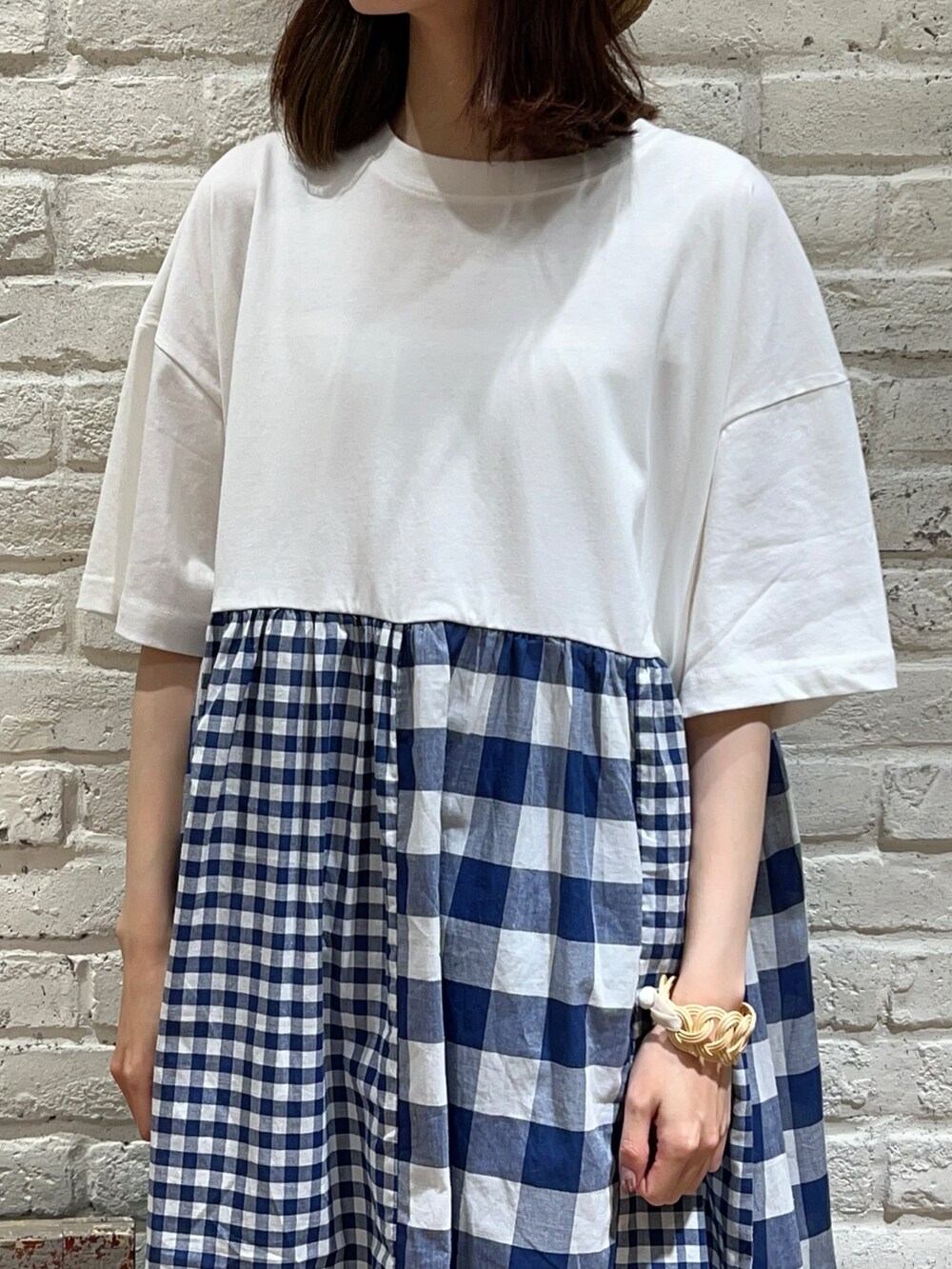 ブルー系のベスト、ホワイト系のワンピース、ホワイト系のハンドバッグを着用したレディースの秋コーディネートの3枚目の写真