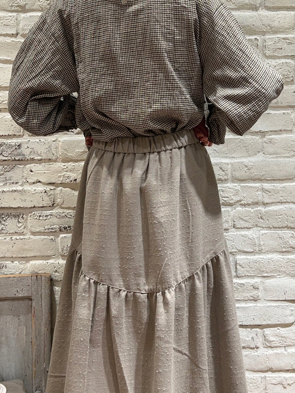 ブラウン系のシャツ/ブラウス、ブラック系のワンピース、ブラウン系のスカートを着用したレディースの冬コーディネートの5枚目の写真