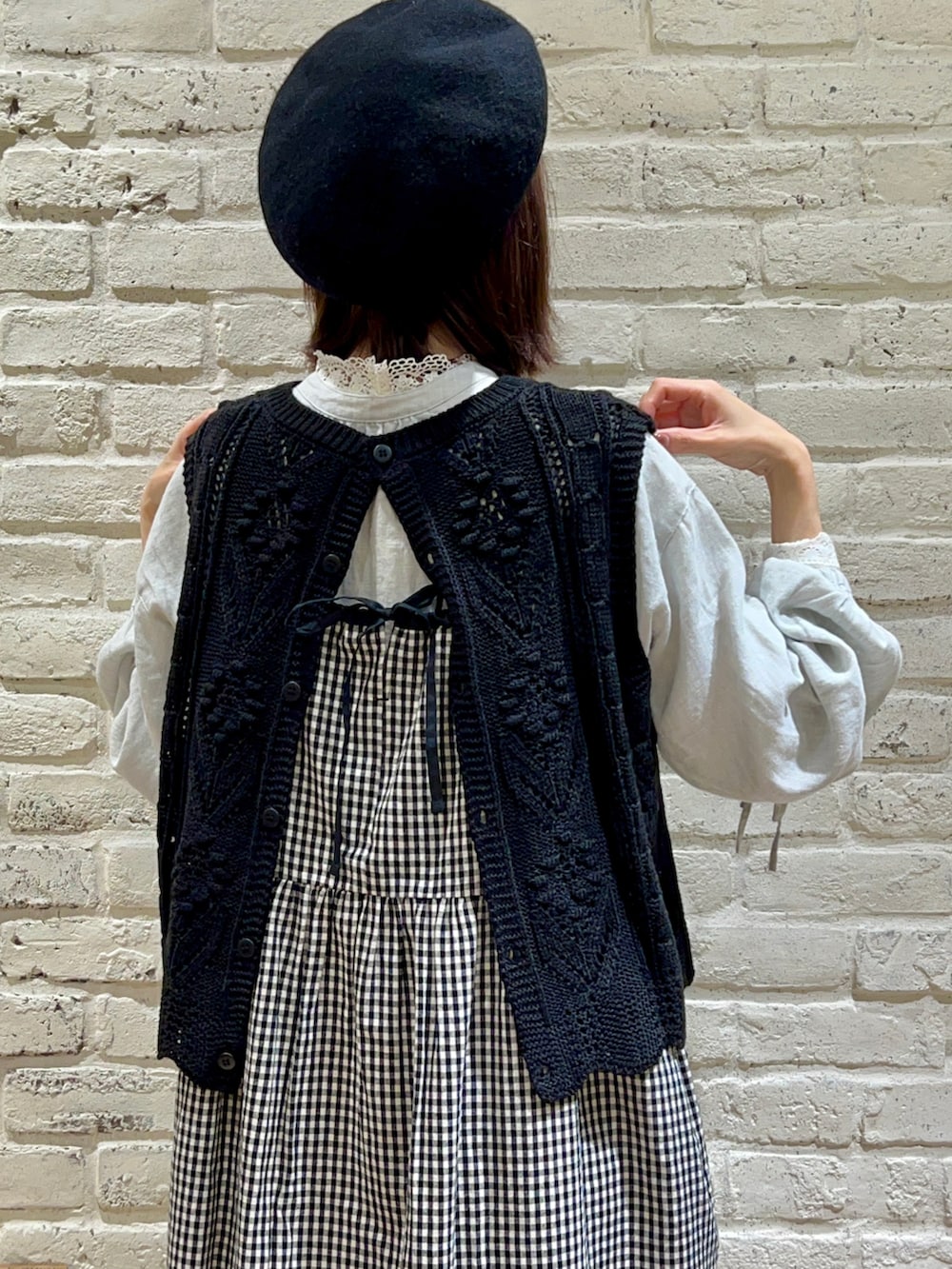 ホワイト系のTシャツ/カットソー、グリーン系のチュニック、ブラック系のカーディガン/ボレロを着用したレディースの冬コーディネートの2枚目の写真