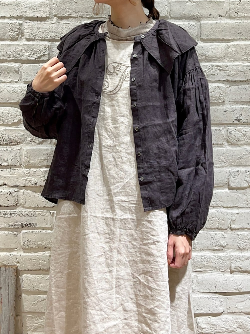 ベージュ系のTシャツ/カットソー、グレー系のシャツ/ブラウス、ベージュ系のワンピースを着用したレディースの冬コーディネートの2枚目の写真