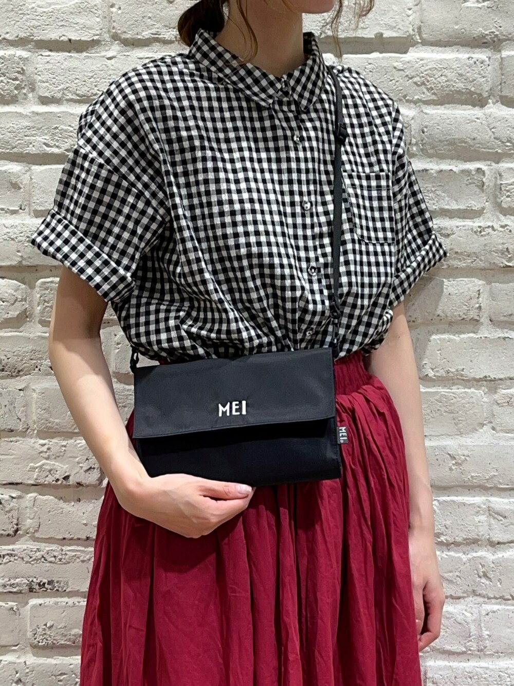 ブラック系のシャツ/ブラウス、ブラック系のボディバッグ/ウエストポーチ、ブラック系のサンダルを着用したレディースの夏コーディネートの2枚目の写真