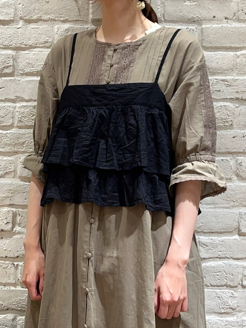 グリーン系のワンピース、ブラック系のシャツ/ブラウス、ベージュ系のスカートを着用したレディースの秋コーディネートの2枚目の写真
