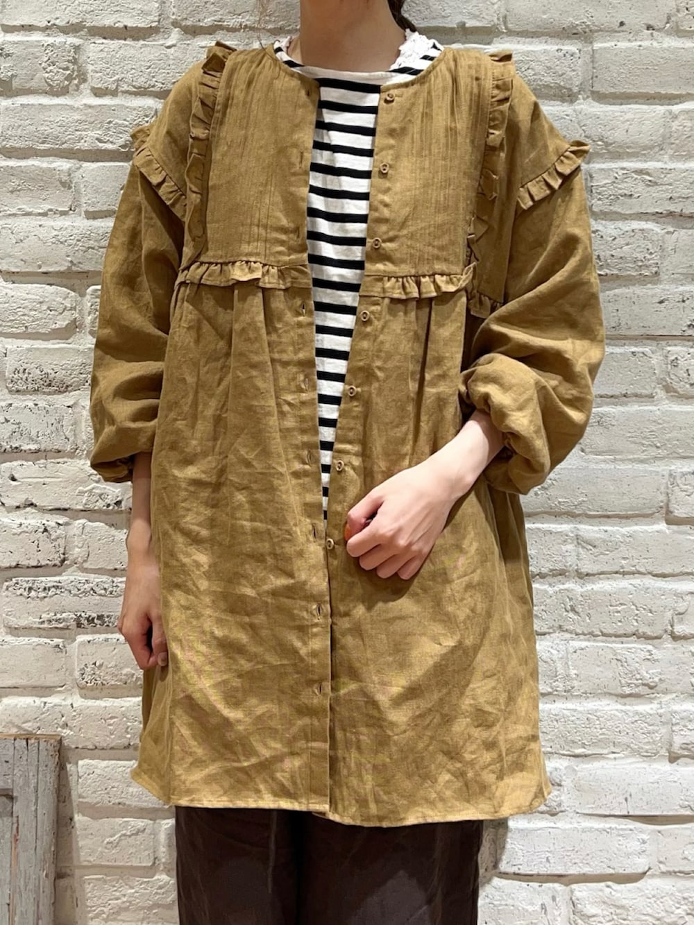 ホワイト系のTシャツ/カットソー、イエロー系のチュニック、グレー系のその他パンツを着用したレディースの秋コーディネートの2枚目の写真