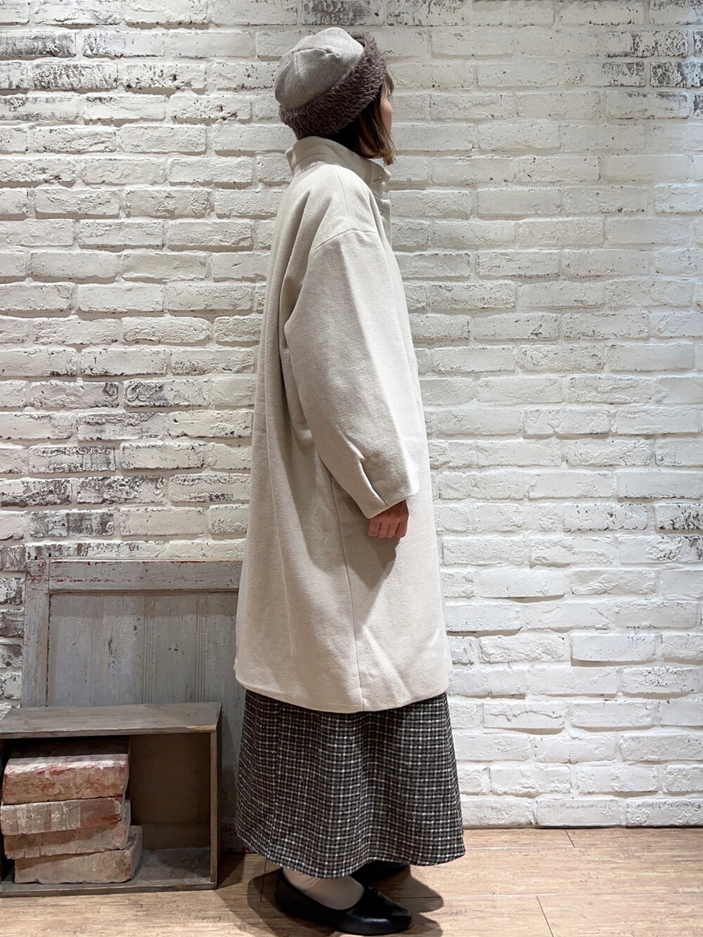 ホワイト系のシャツ/ブラウス、ベージュ系のニット/セーター、ホワイト系のその他アウターを着用したレディースの冬コーディネートの2枚目の写真