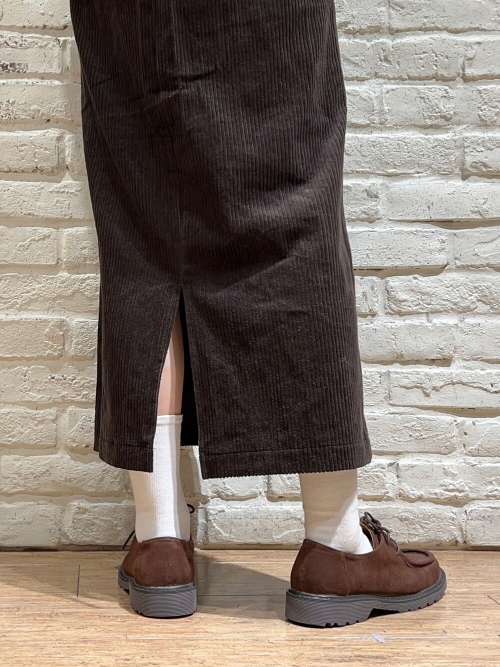 ブラウン系のシャツ/ブラウス、ベージュ系のニット/セーター、グレー系のスカートを着用したレディースの冬コーディネートの5枚目の写真