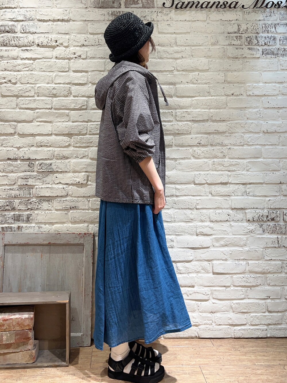 ベージュ系のTシャツ/カットソー、ブルー系のスカート、ブラック系のサンダルを着用したレディースの春コーディネートの4枚目の写真