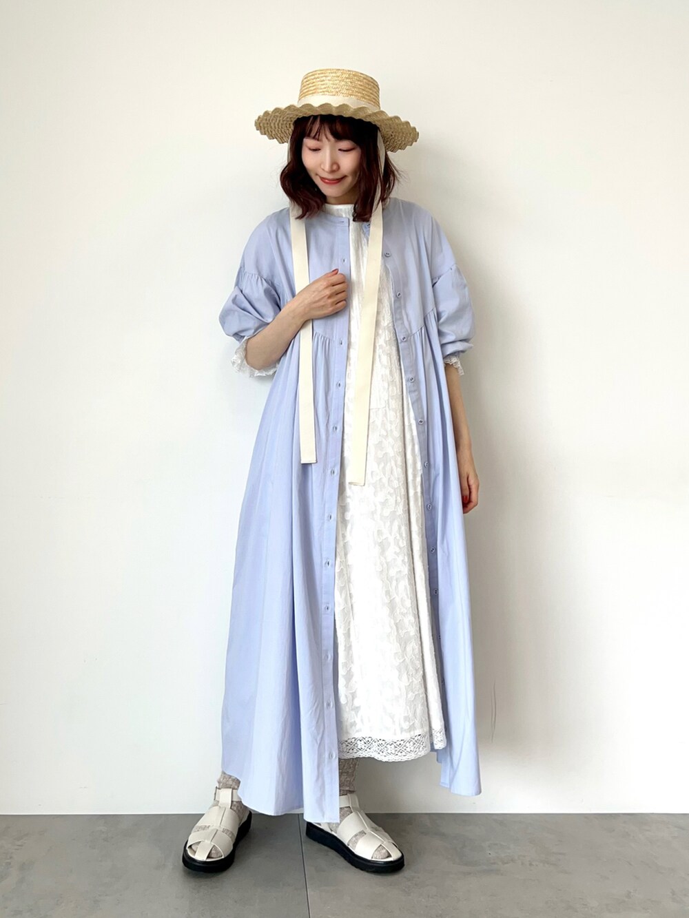 パープル系のワンピース、ホワイト系のワンピース、ホワイト系のサンダルを着用したレディースの春コーディネートの3枚目の写真