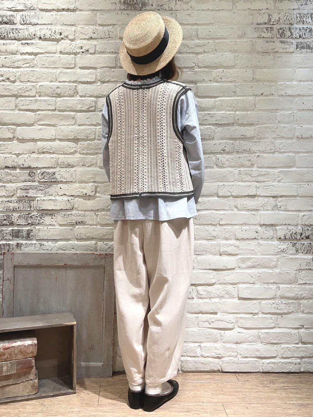 ブルー系のシャツ/ブラウス、ホワイト系のベスト、ブラック系のハンドバッグを着用したレディースの春コーディネートの4枚目の写真