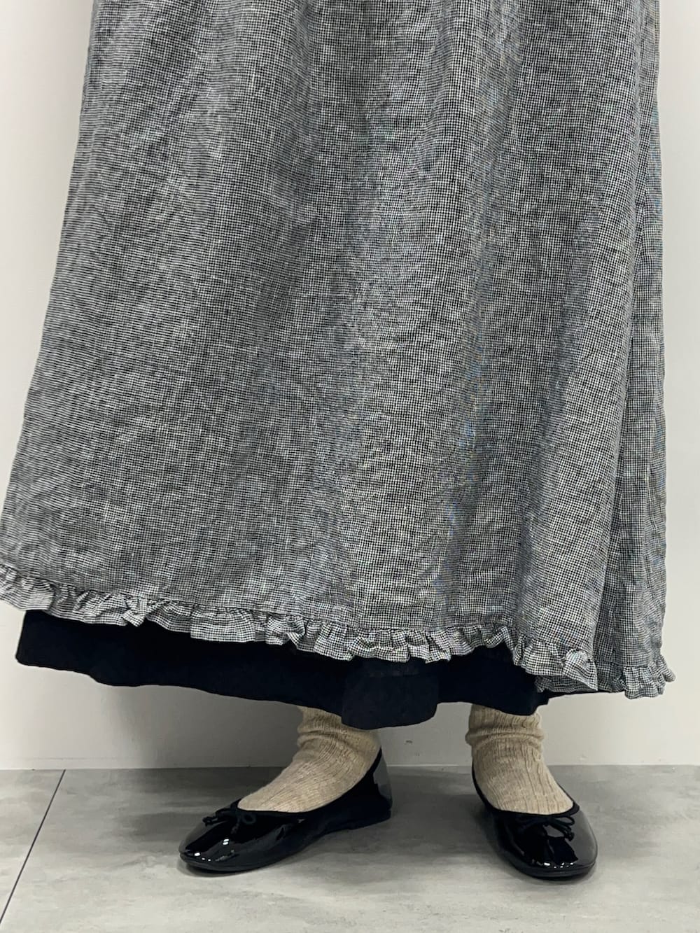 ホワイト系のTシャツ/カットソー、ブラック系のワンピース、ブラック系のスカートを着用したレディースの春コーディネートの5枚目の写真