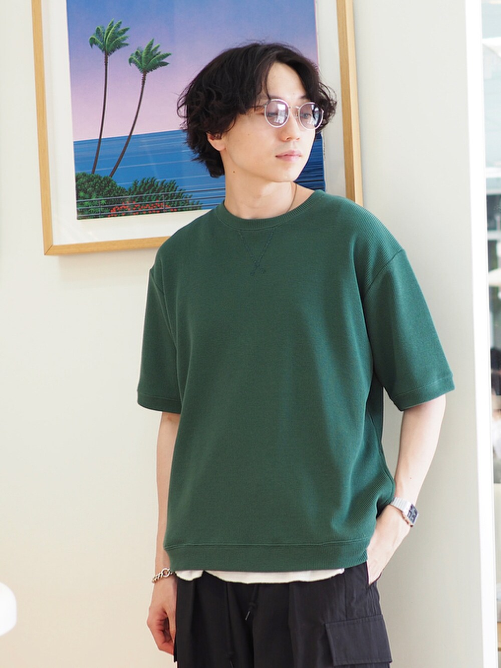 グリーン系のTシャツ/カットソー、ブラック系のカーゴパンツ、ブラック系のサンダルを着用したメンズの春コーディネートの2枚目の写真