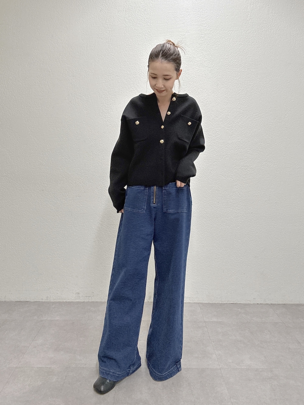 ブルー系のデニムパンツ、ブラック系のカーディガン/ボレロを着用したレディースの秋コーディネートの3枚目の写真