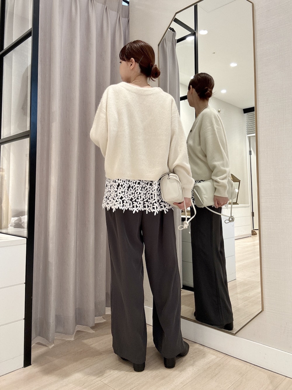 ホワイト系のカーディガン/ボレロ、ホワイト系のキャミソール、グレー系のその他パンツを着用したレディースの秋コーディネートの4枚目の写真