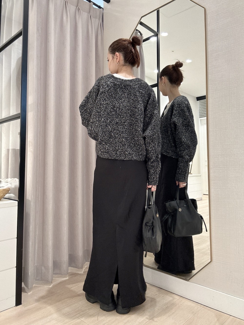 ブラック系のカーディガン/ボレロ、ホワイト系のTシャツ/カットソー、ブラック系のスカートを着用したレディースの秋コーディネートの4枚目の写真