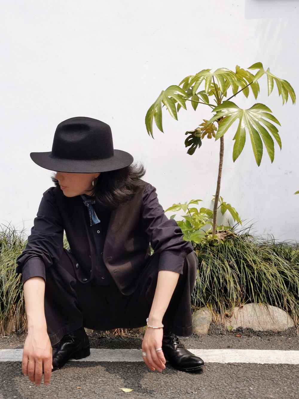 ブラック系のシャツ/ブラウス、ブラック系のブーツを着用したレディースの春コーディネートの2枚目の写真