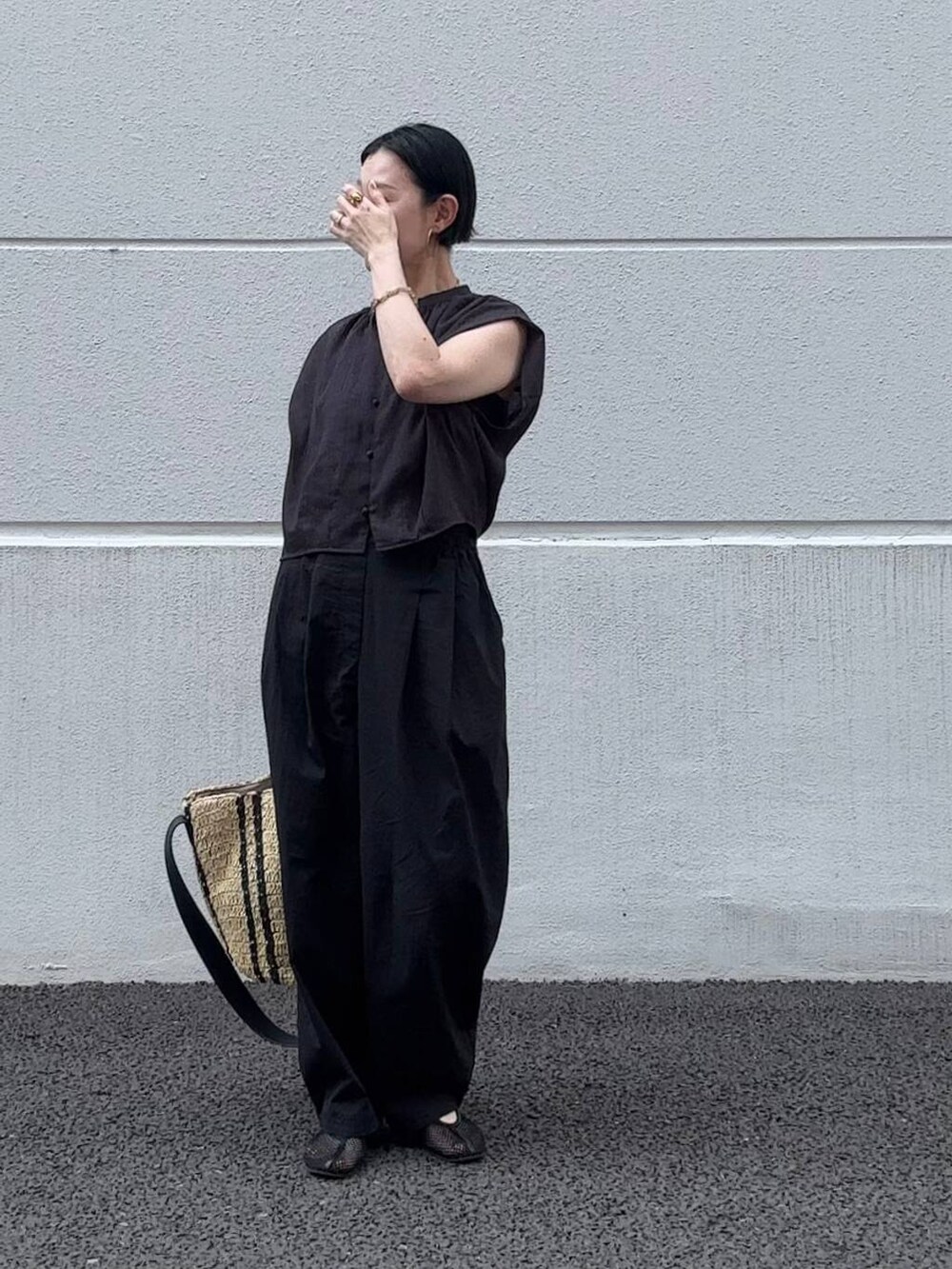 ホワイト系のその他パンツ、ベージュ系のトートバッグ、ブラック系のパンプスを着用したレディースの夏コーディネートの2枚目の写真