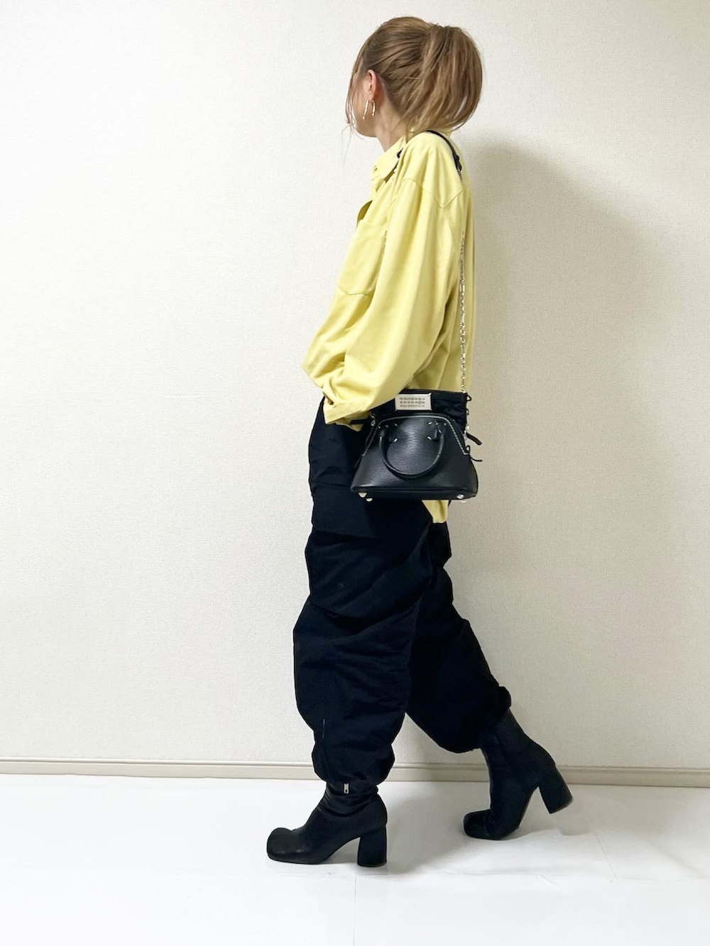 イエロー系のシャツ/ブラウス、ブラック系のカーゴパンツを着用したレディースの冬コーディネートの2枚目の写真